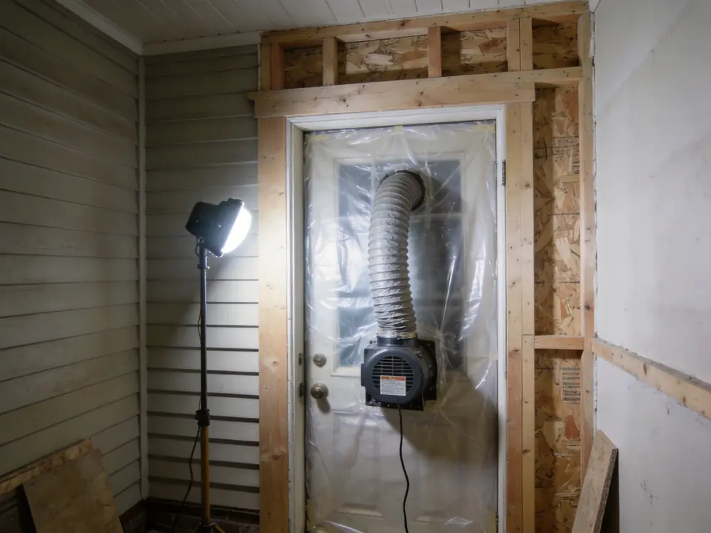 Negative air machine ducted through containment sheeting
