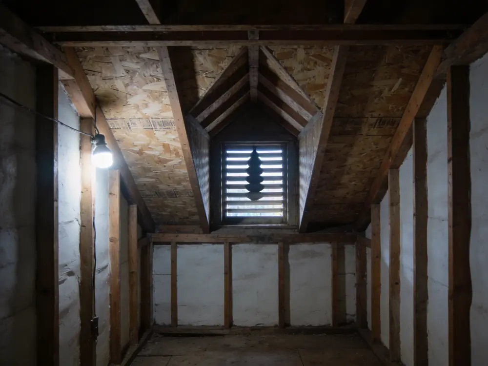 Gable vent seen from inside a dim attic