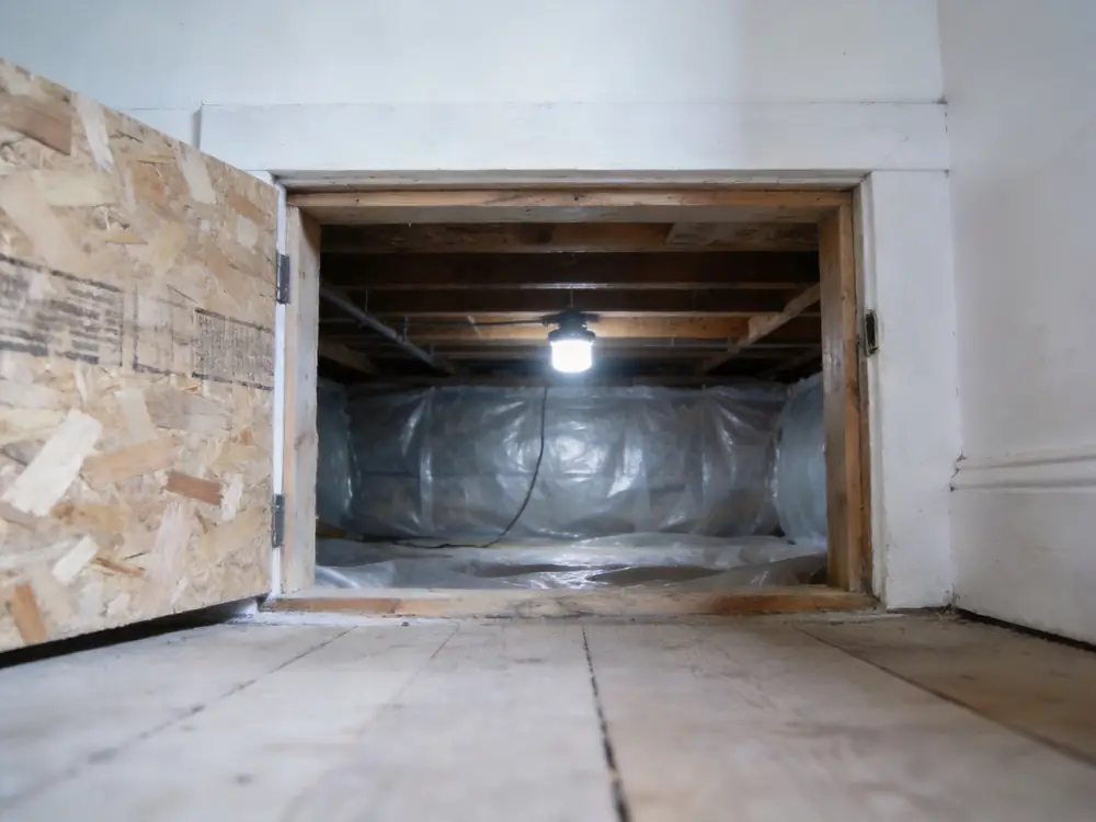 Open crawl space hatch with encapsulation sheeting visible inside