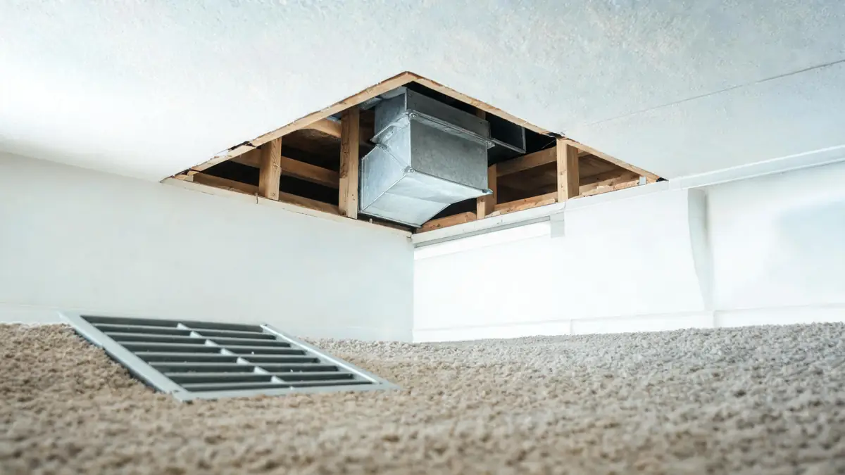 Ceiling supply register removed to show the duct boot above