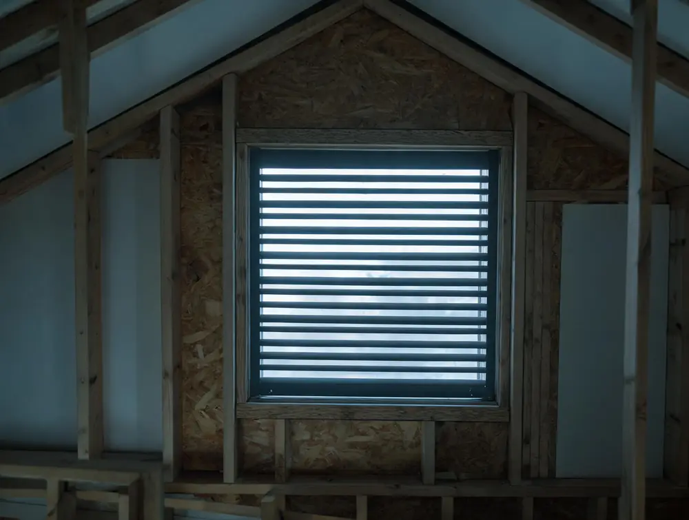 Gable vent seen from inside a dim attic