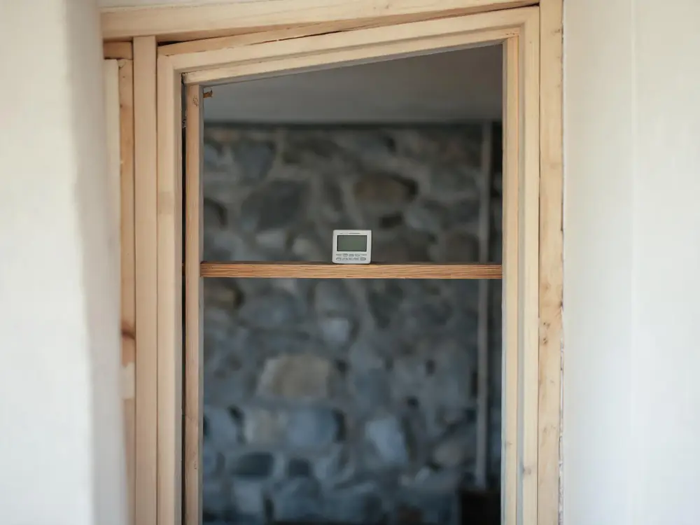 Digital hygrometer showing high humidity in a basement
