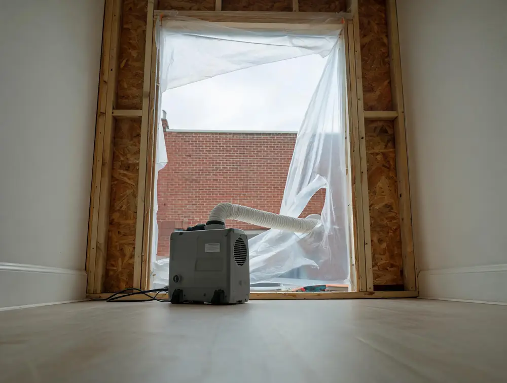 Negative air machine ducted through containment sheeting