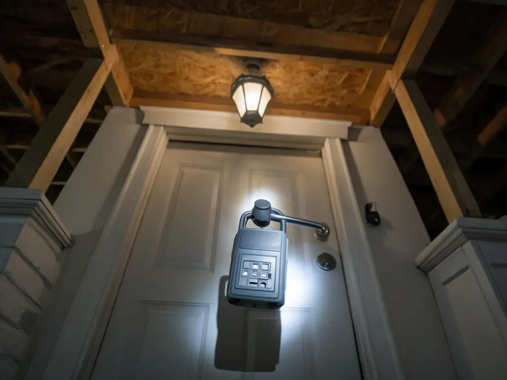 Real estate lockbox on the front door of an older house