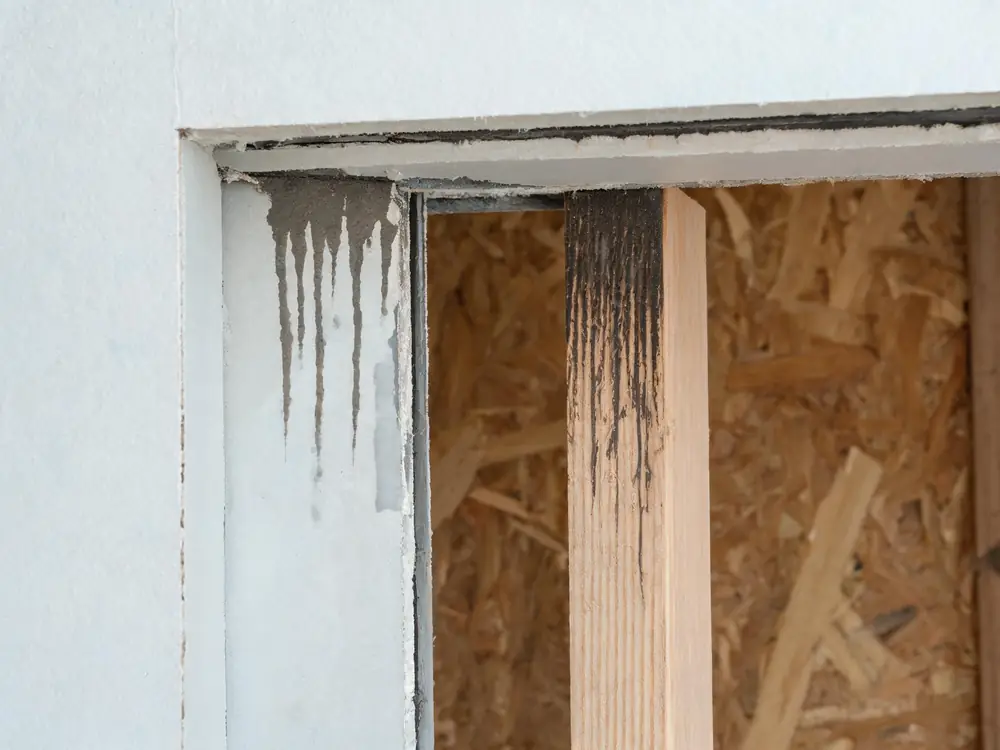 Wall cavity opened to expose staining on the back of the drywall